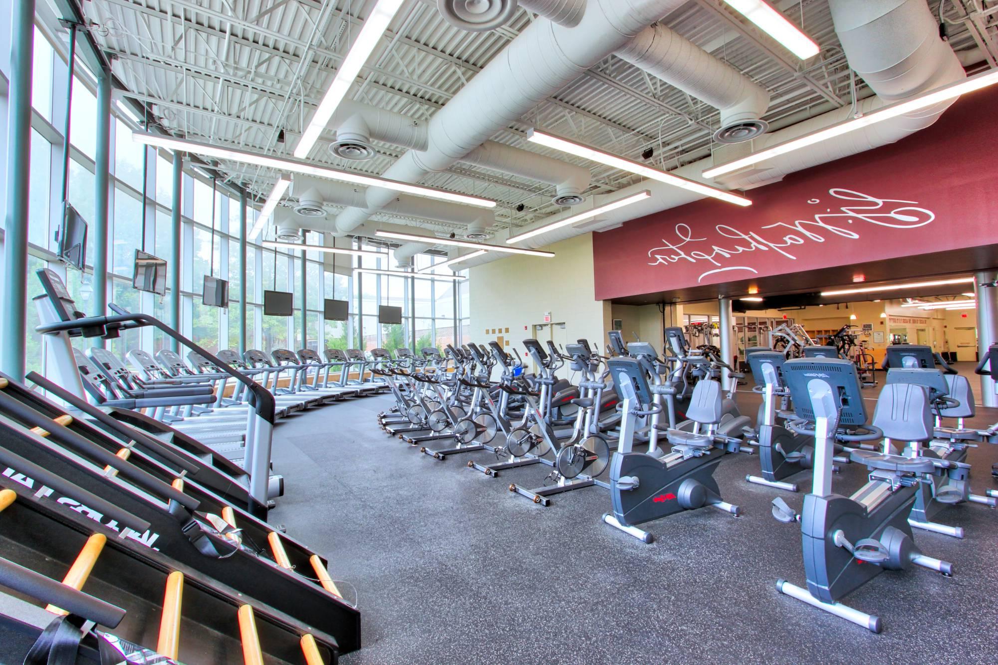 treadmills and stationary bikes in fitness cener